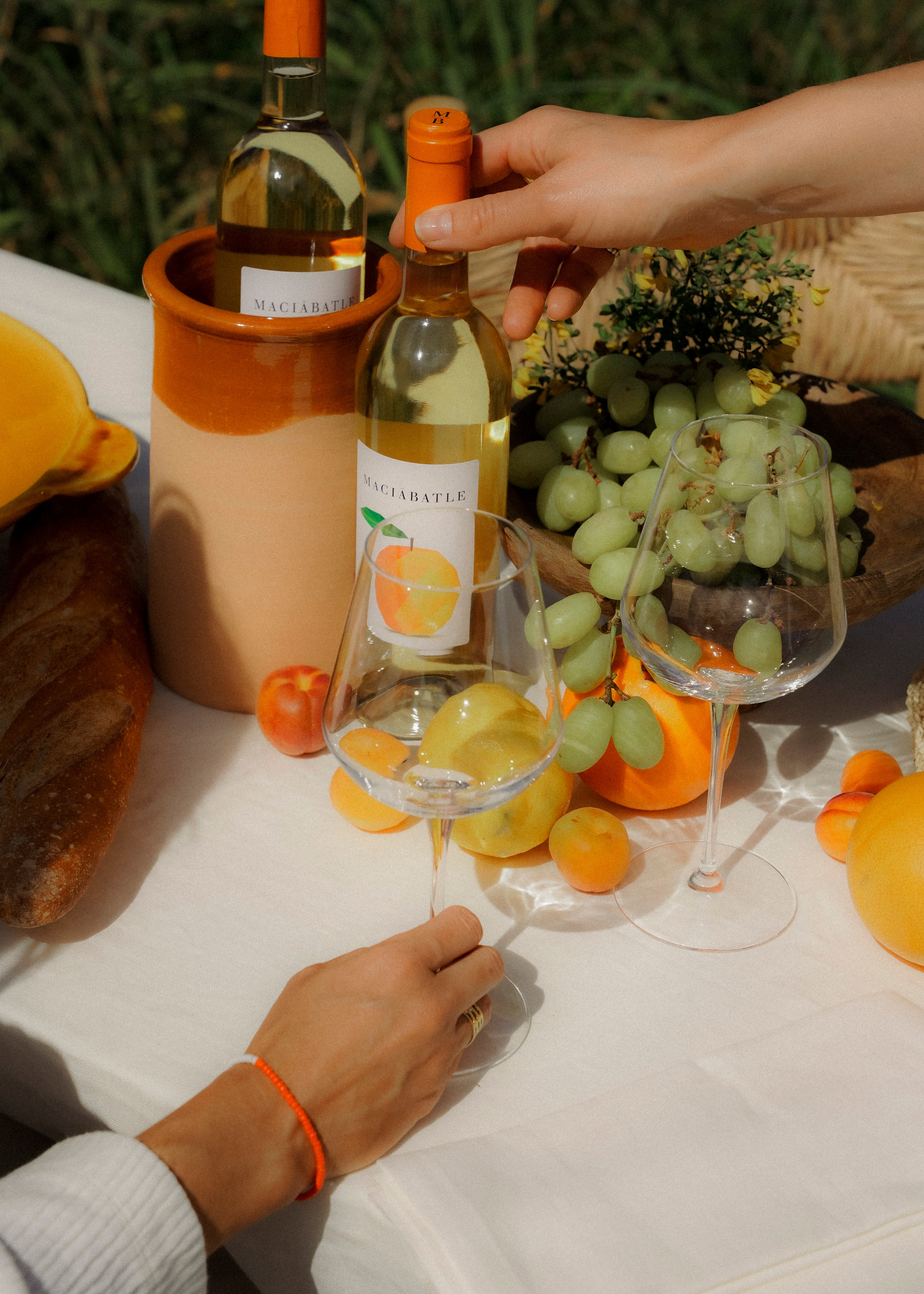 Winecooler with orange wine at table setting
