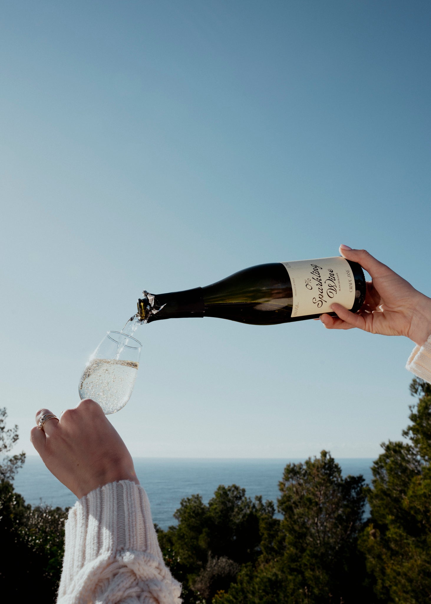 Bottle of non alcohol sparkling wine pouring in a glass