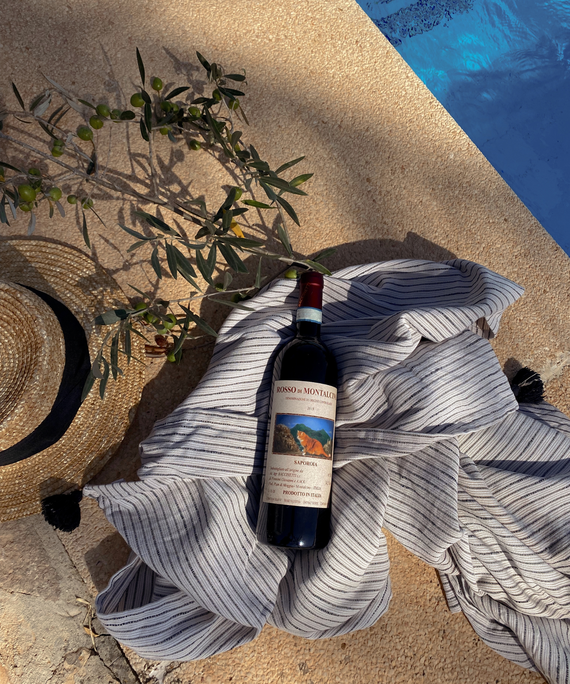 bottle of Rosso di Montalcino next to a pool